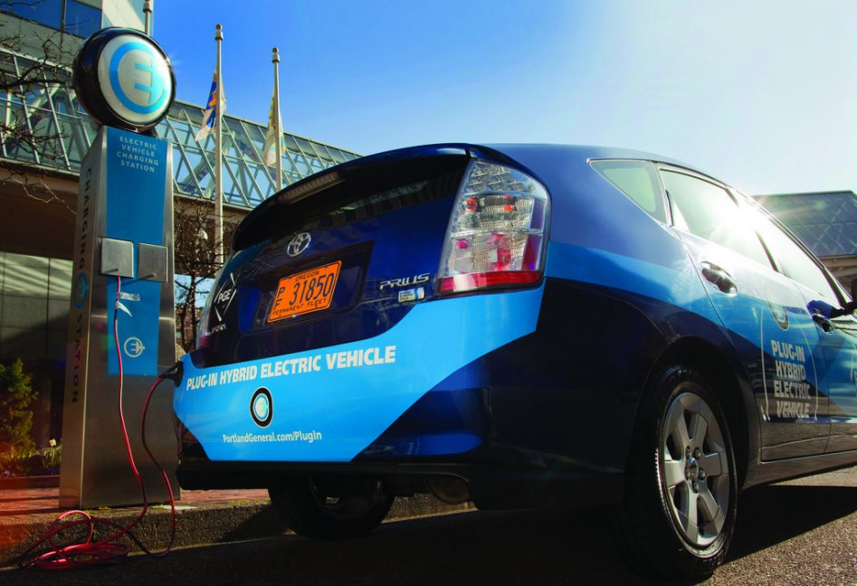 Coche eléctrico recargando en un punto de carga.